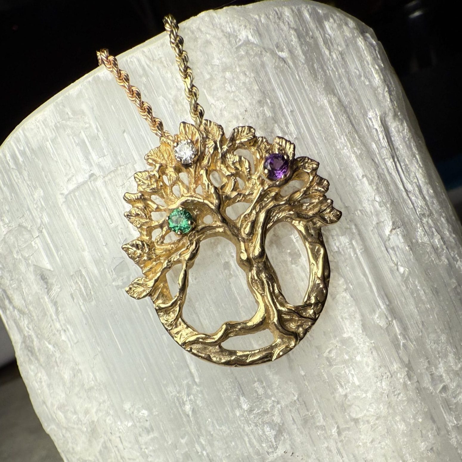 Custom gold tree pendant with gemstones by Charlotte's Fine Jewelry in Seattle, WA